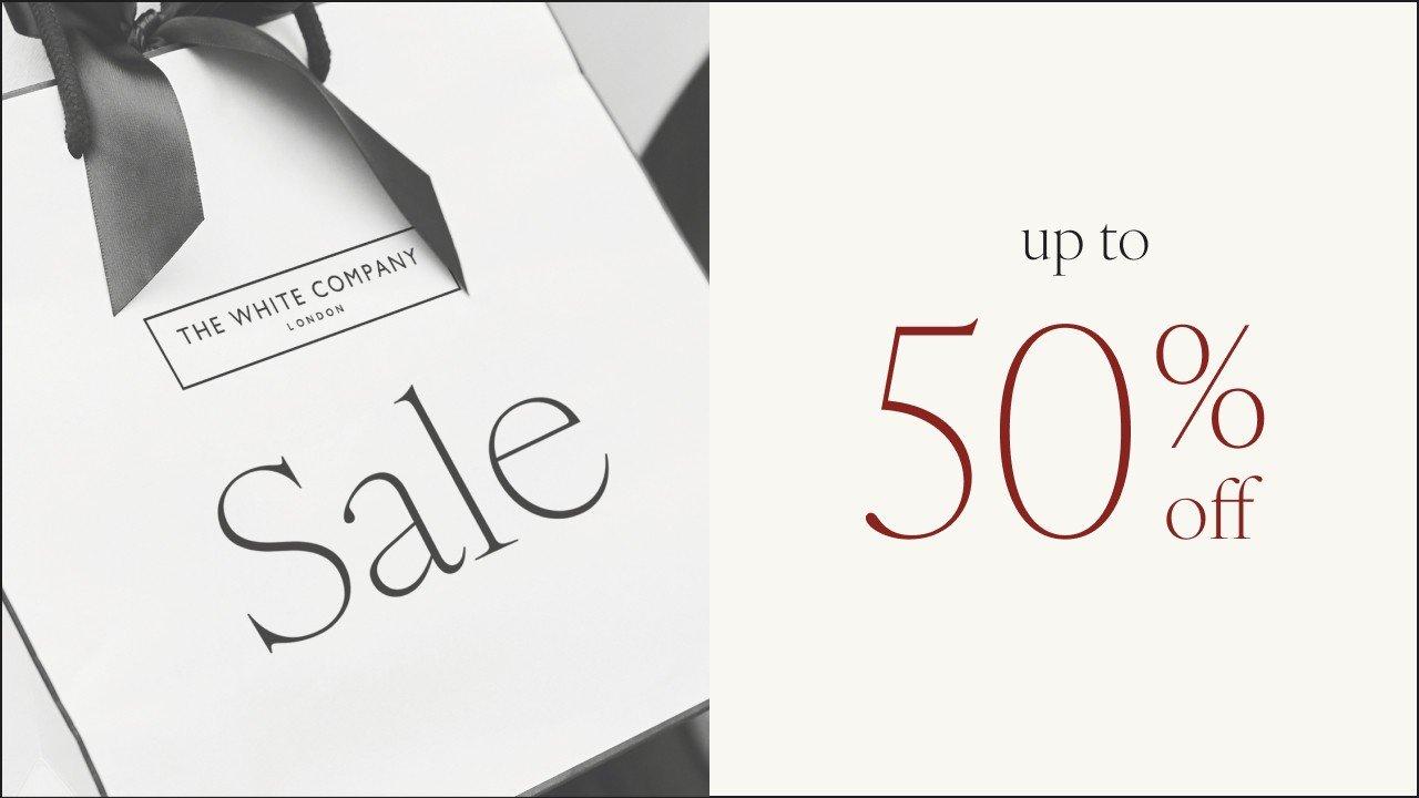 a white box with a black ribbon and a 50 % off sign