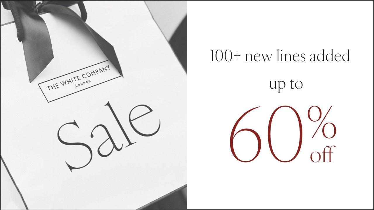 a white bag with a black ribbon and the words up to 60 % off