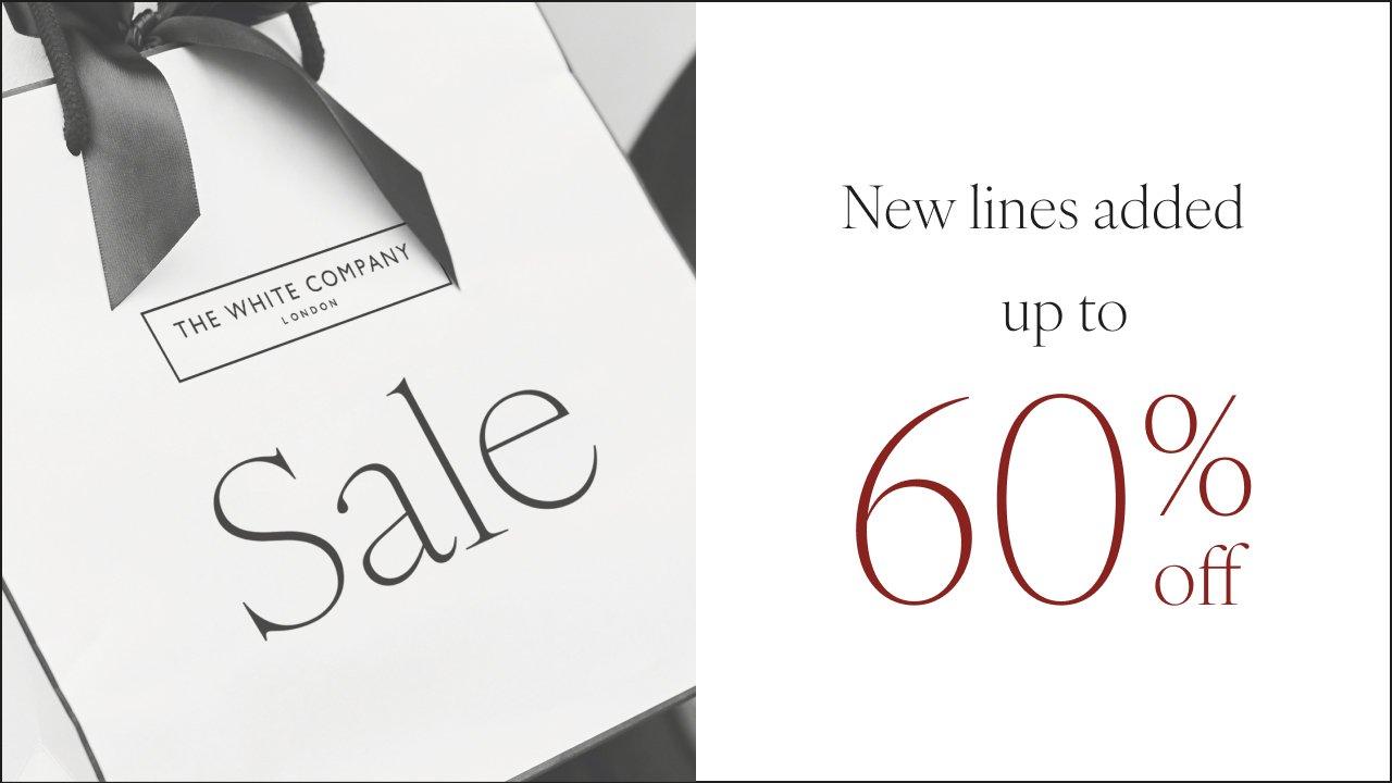 a black and white photo of a white bag with a sale sign