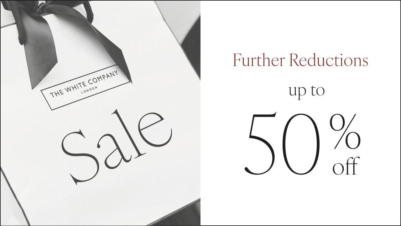 a white box with a black ribbon and a 50 % off sign