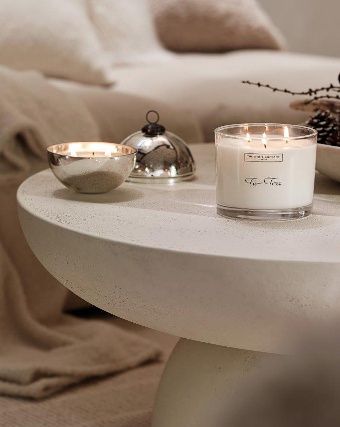 a candle on a table with a candle holder and a candle