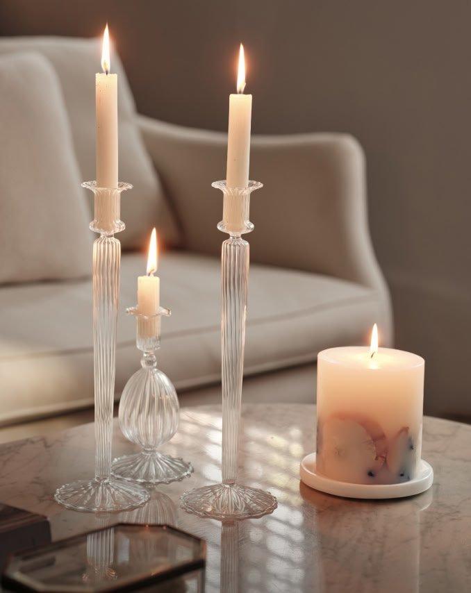 a table with three candles and a small candle on it