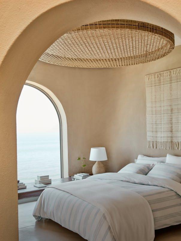 a bedroom with a bed and a lamp on a table