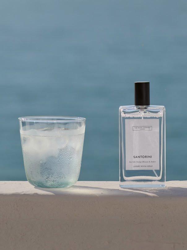 a glass of a glass of water and a bottle of perfume