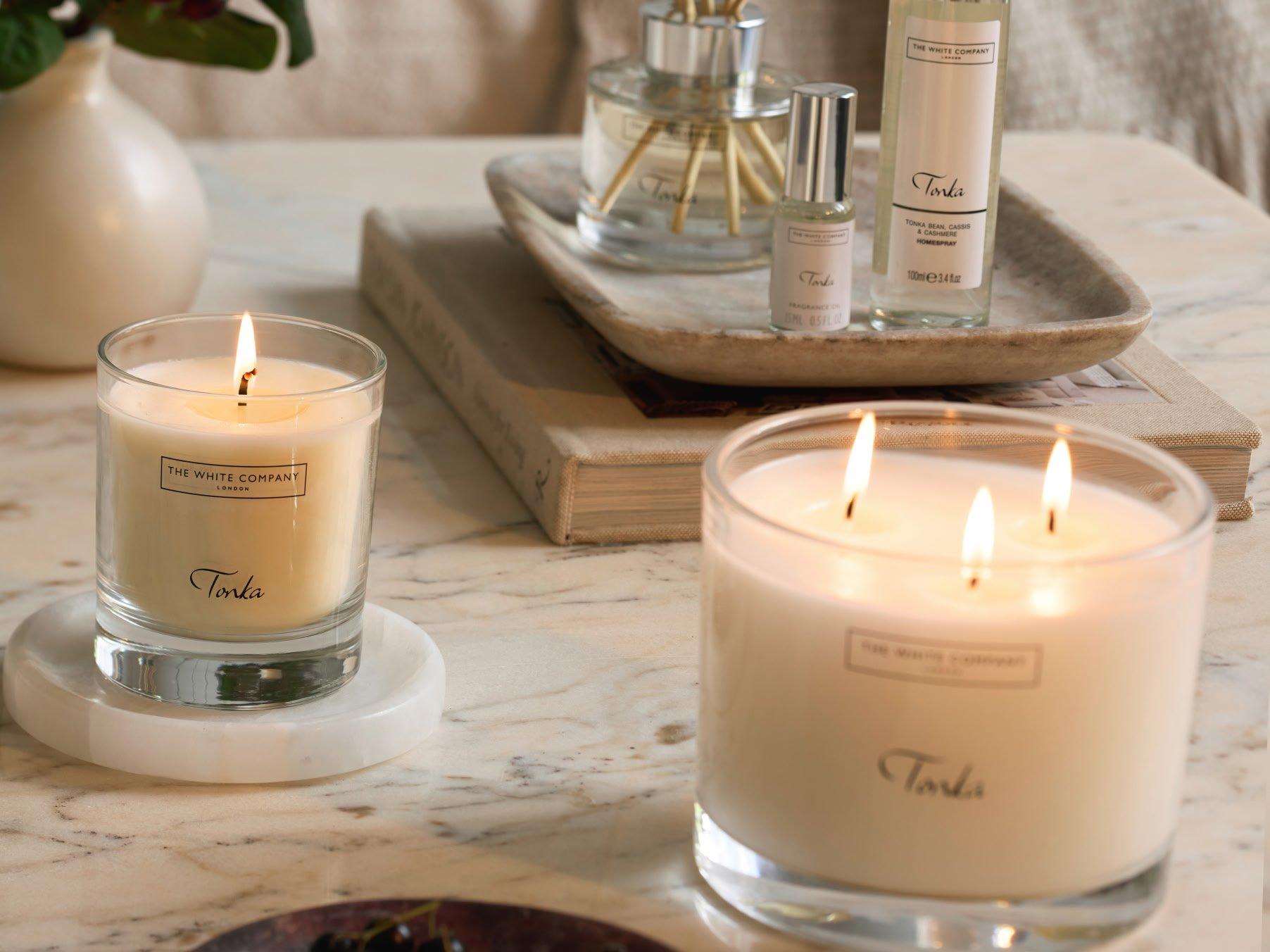 a table with candles and other items on it in a room