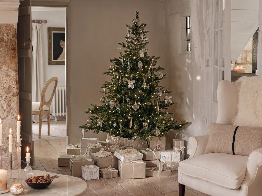 a living room with a christmas tree and presents under it