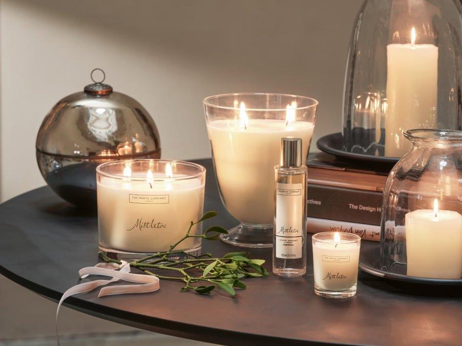 a table with candles and other items on it sitting on a table