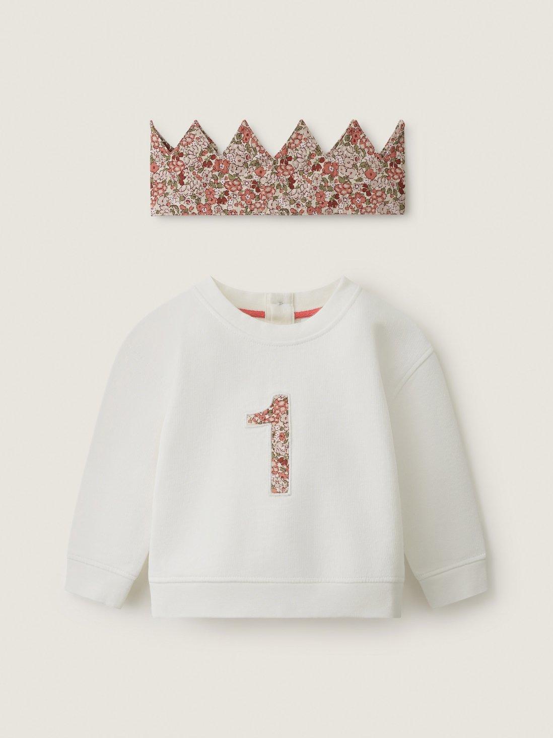 jumper with number one on and a crown