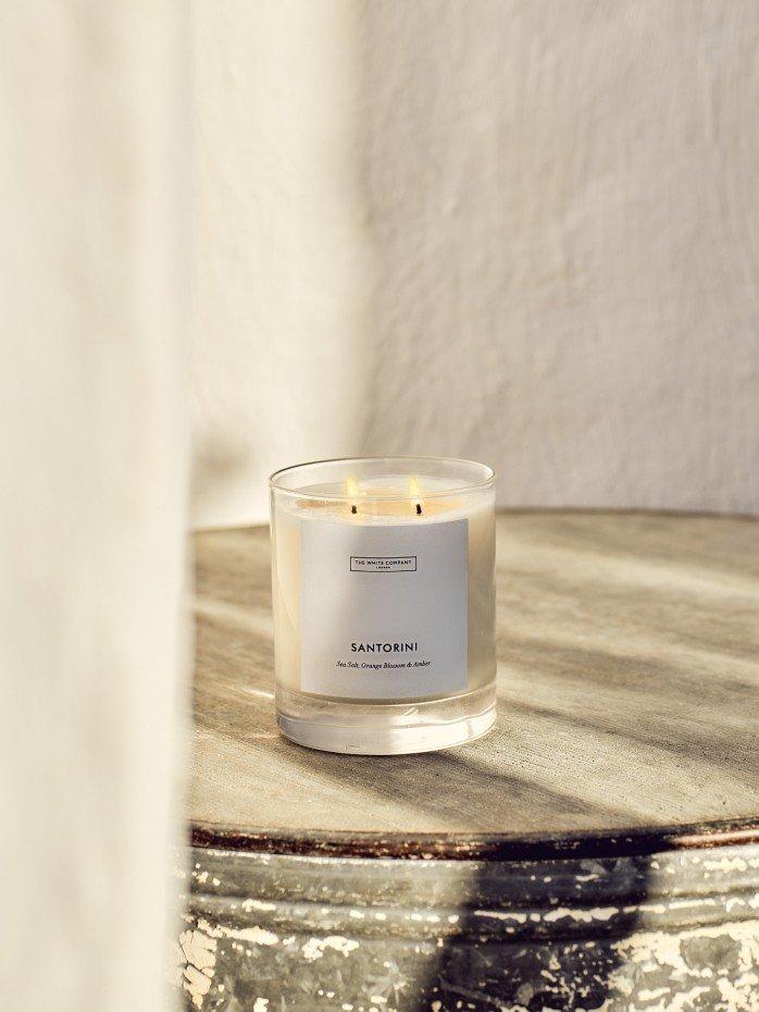 a candle sitting on top of a table next to a window