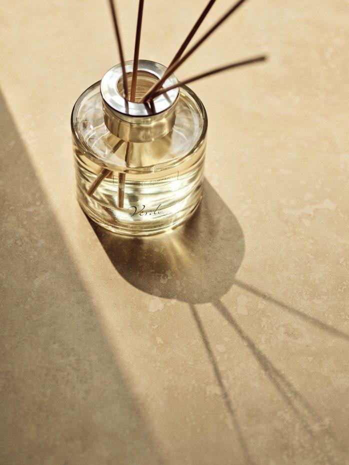 a glass jar with sticks of incense in it on a table