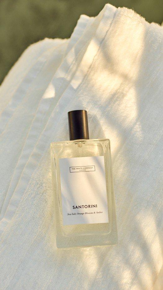 a bottle of perfume sitting on top of a white towel