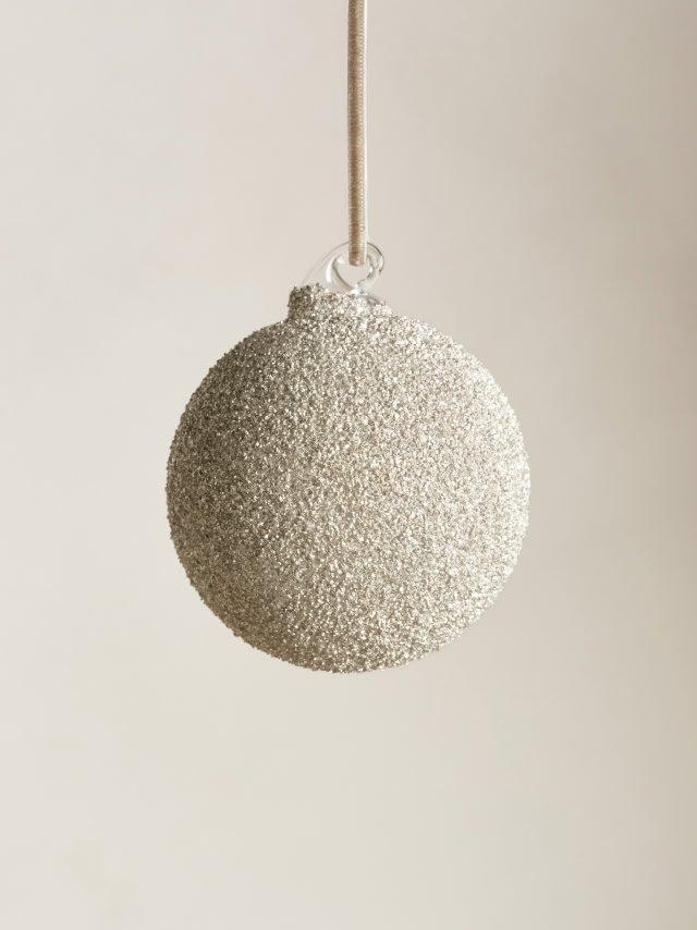 a close up of a silver ball hanging from a string