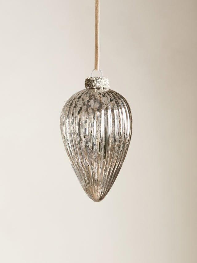 a glass ball hanging from a string on a wall