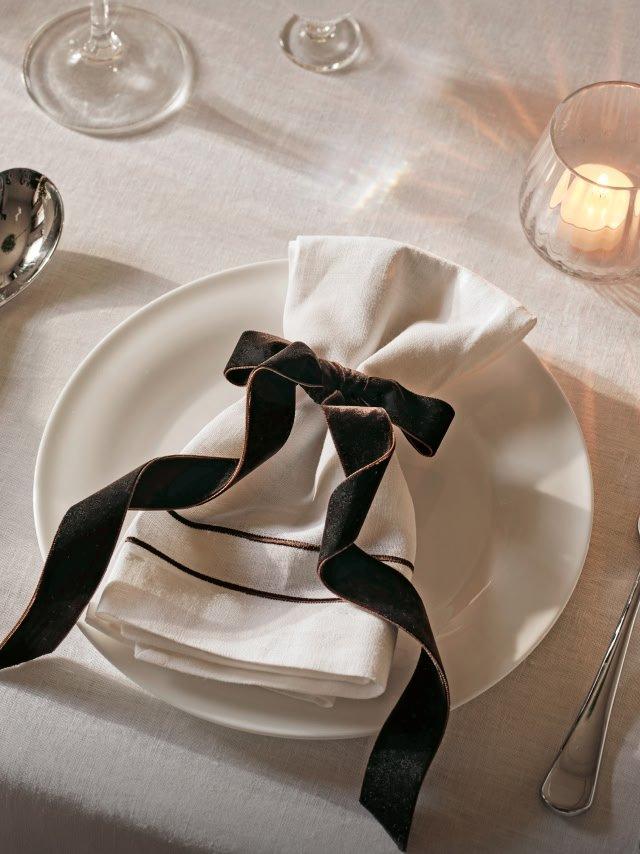 a white plate with a napkin and silverware on it