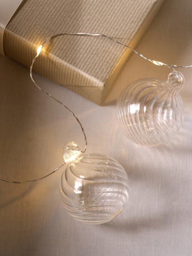 a box with a string of lights and a glass ornament