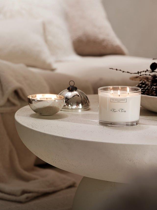 a table with a candle and two bowls on it
