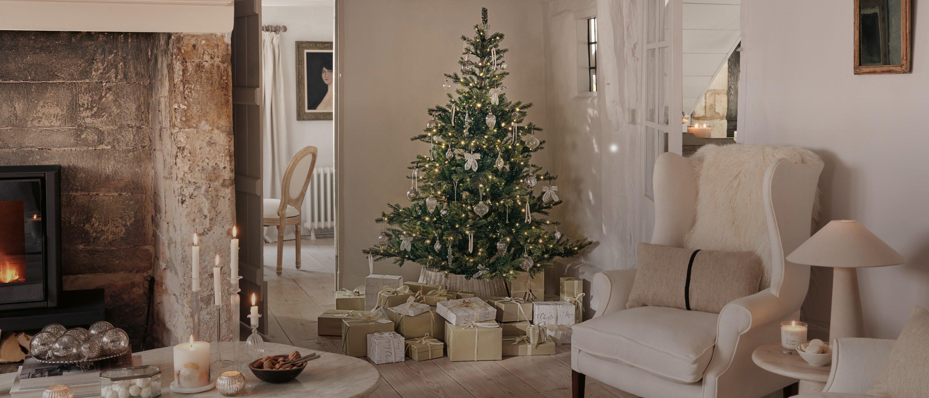 a living room with a fireplace and a christmas tree