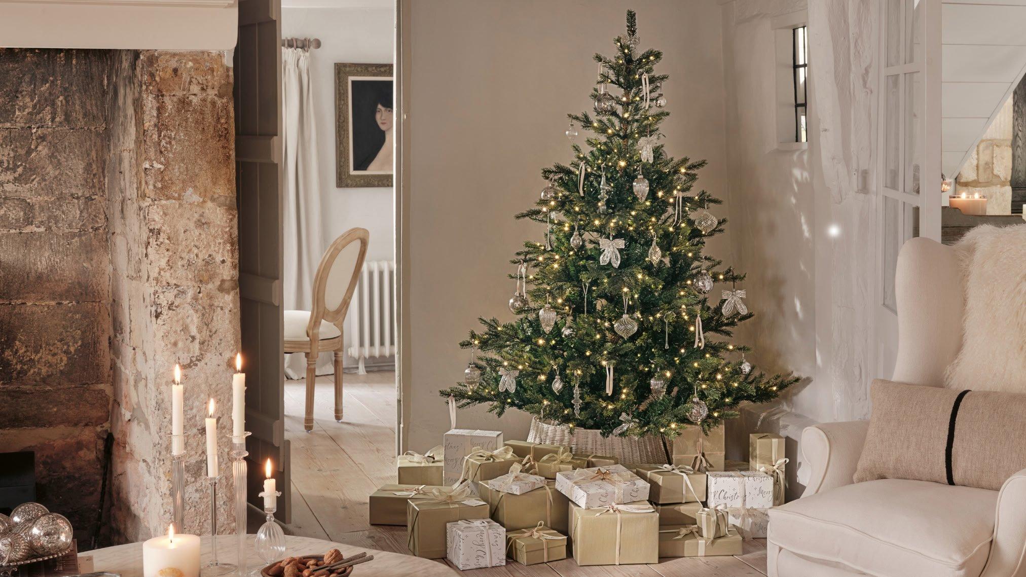a living room with a christmas tree and presents under it