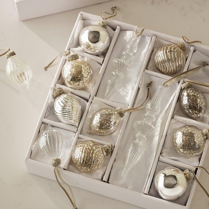 a white box with silver and gold ornaments in it