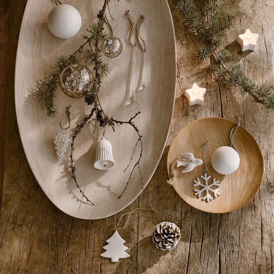 a wooden table with a plate of ornaments and a star