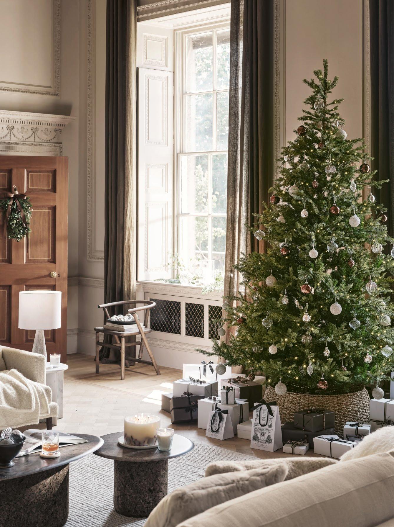 a living room with a christmas tree in it and a couch