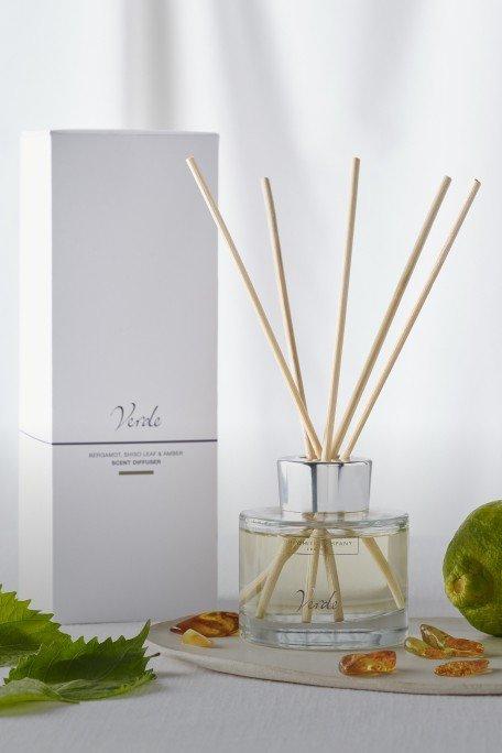 a bottle of reed diffuser, a box of lemons and a leaf