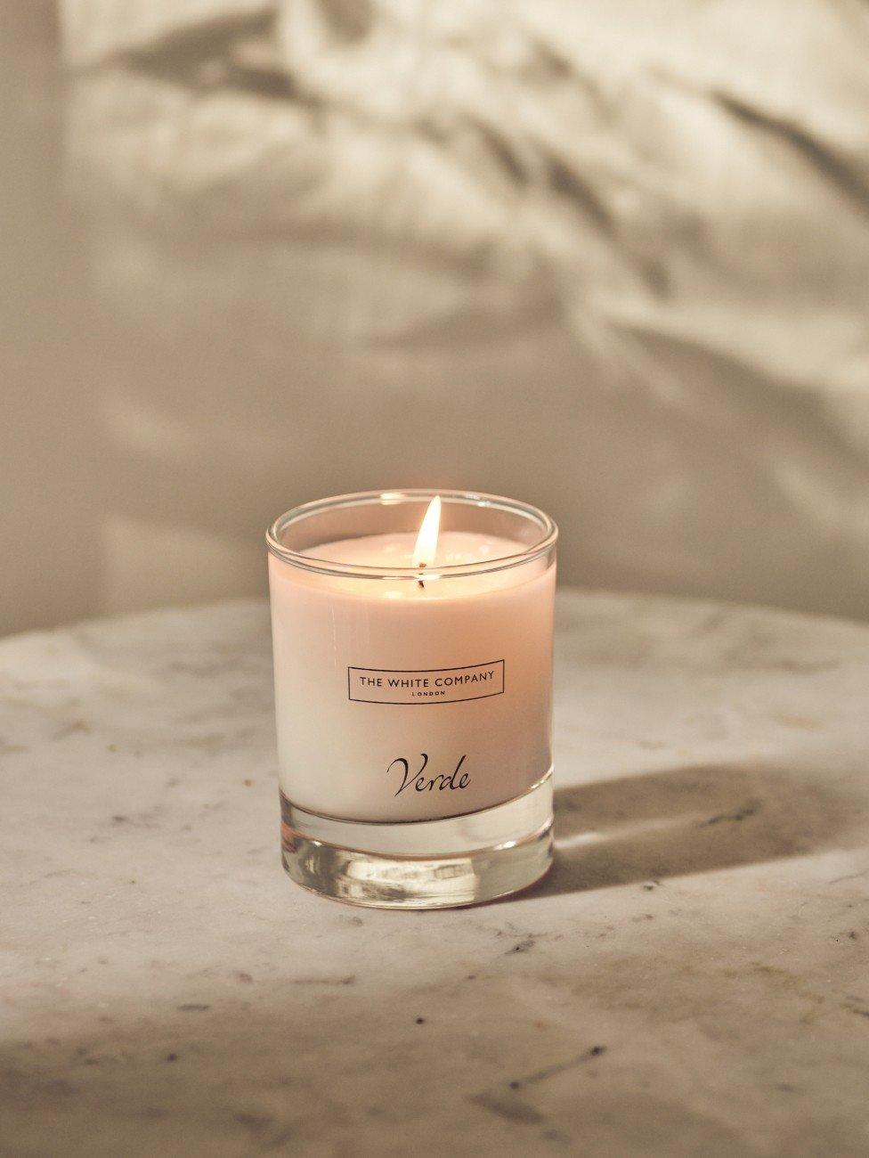a candle sitting on a marble table with a white background