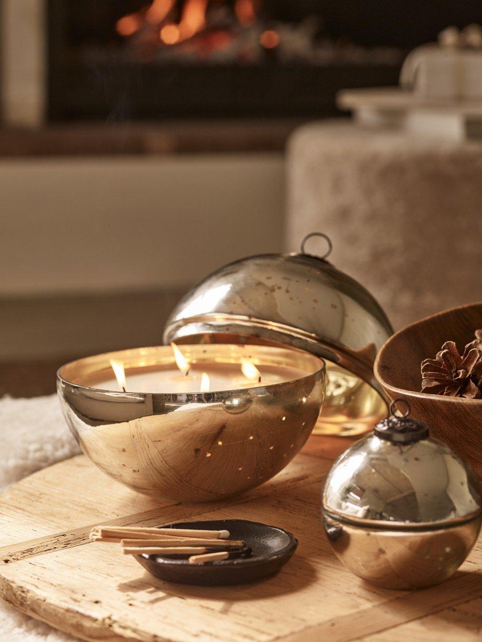 a table with candles and a log on it with a candle