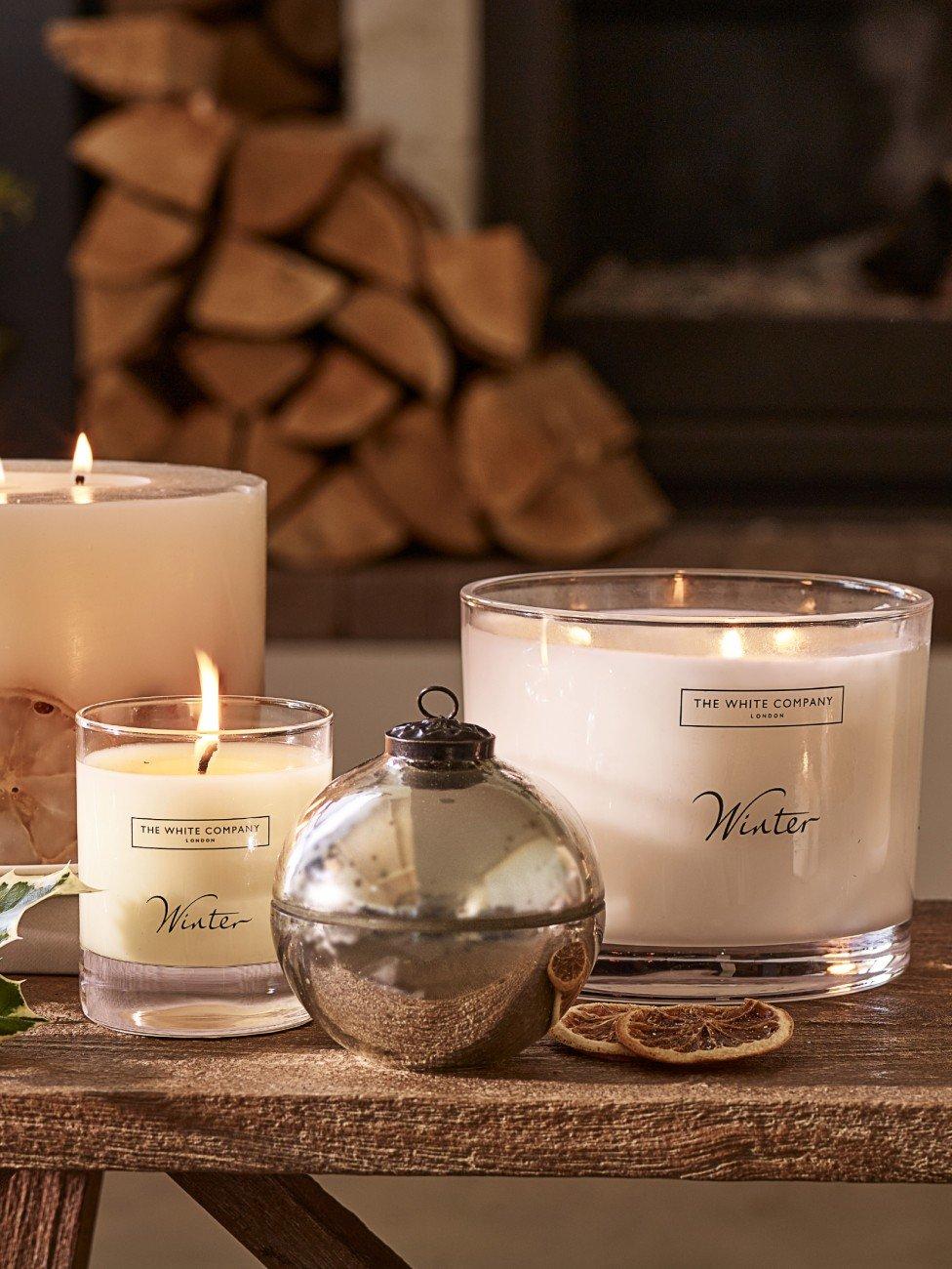 a table with candles and a log on it with a candle