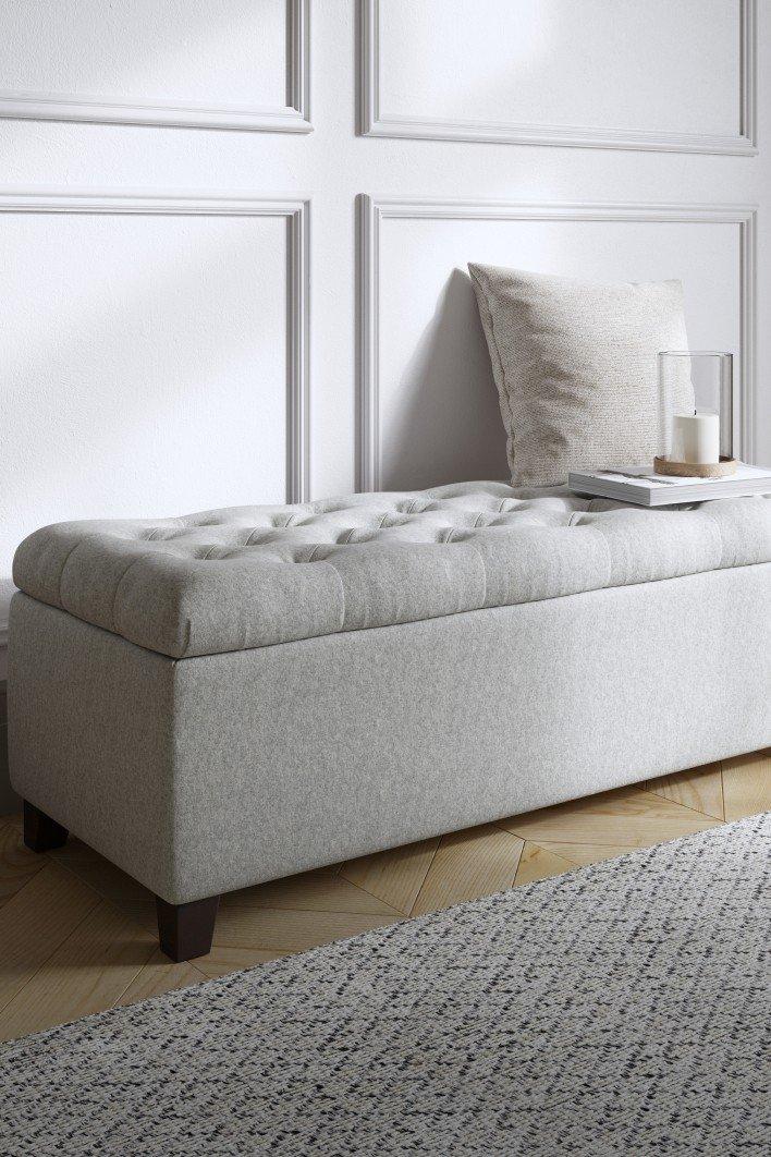 a white bench with a candle on it in a room