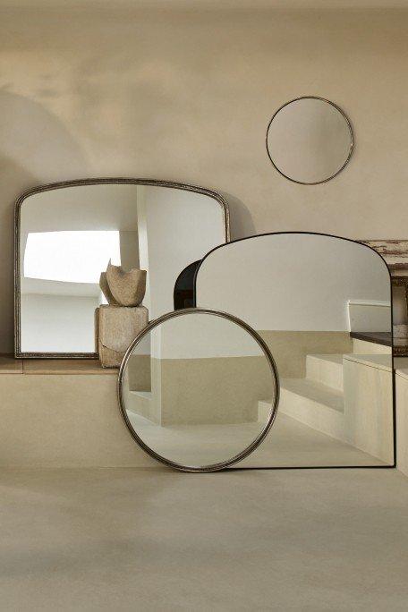 a group of mirrors are on a wall in a room