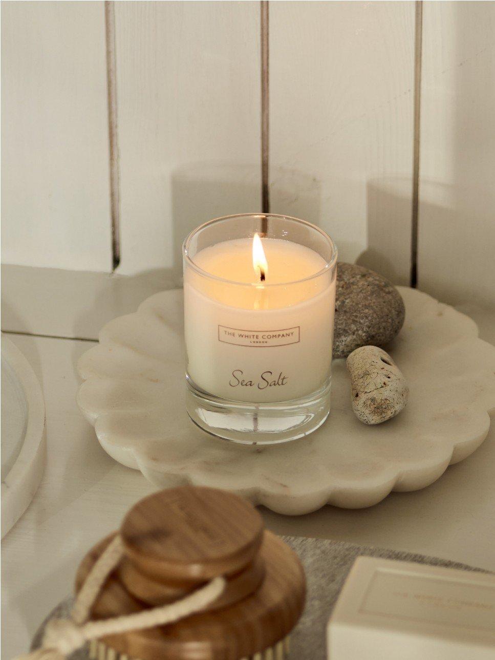 a close up of a candle and a diffuser on a table