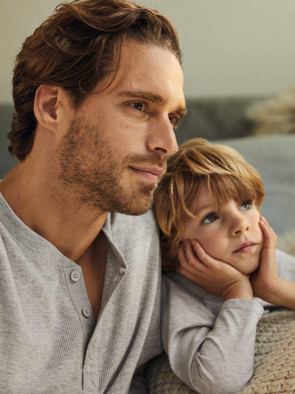 a man and a child sitting on a couch together