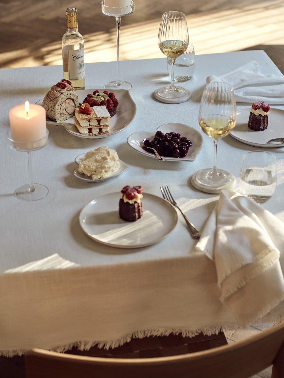 a table with a white cloth and candles on it