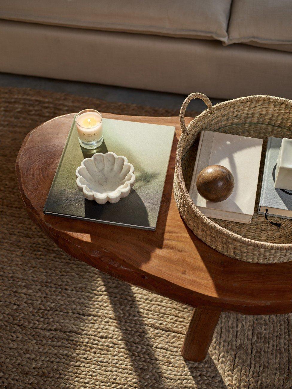 a table with a basket on top of it and a candle on the table