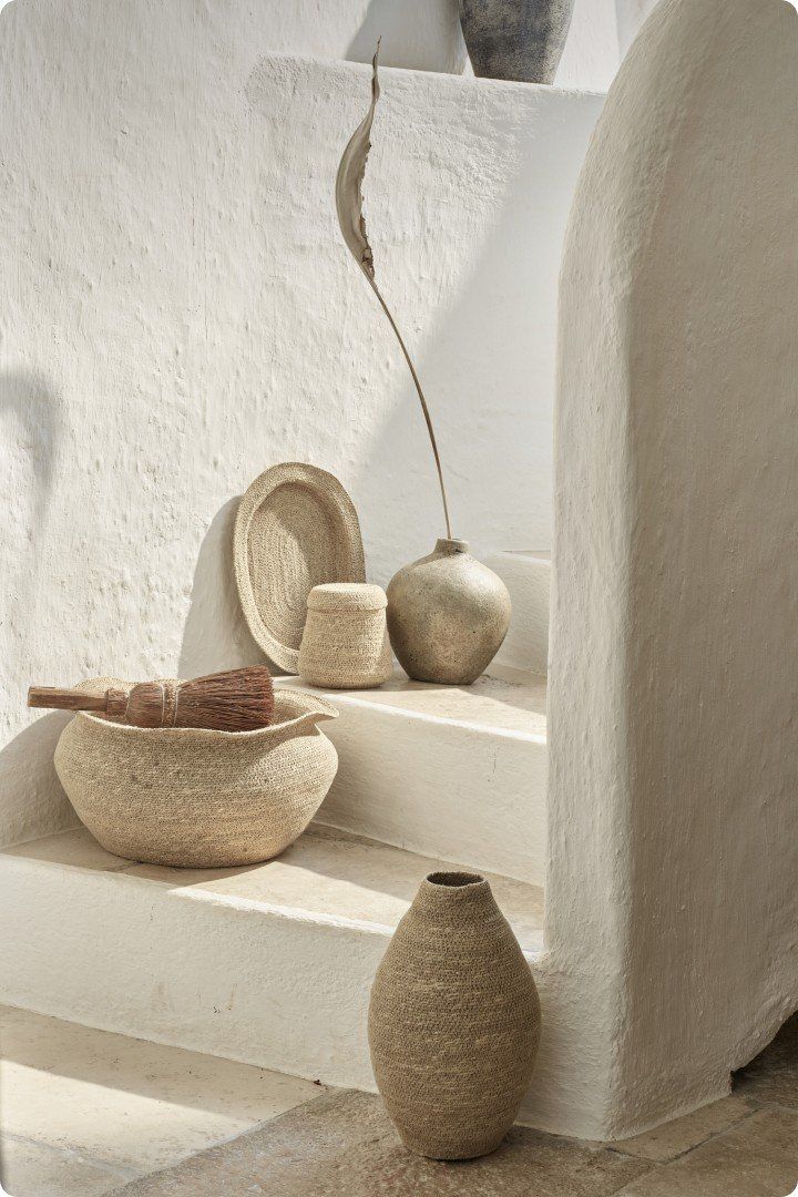 a bunch of pots and vases on a white stairway