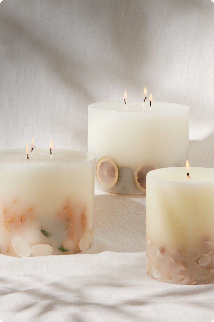 three candles with different designs on them are sitting on a table