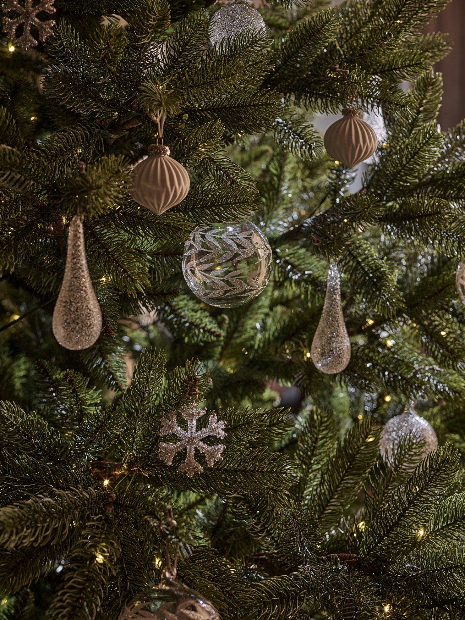 a close up of a christmas tree with ornaments on it