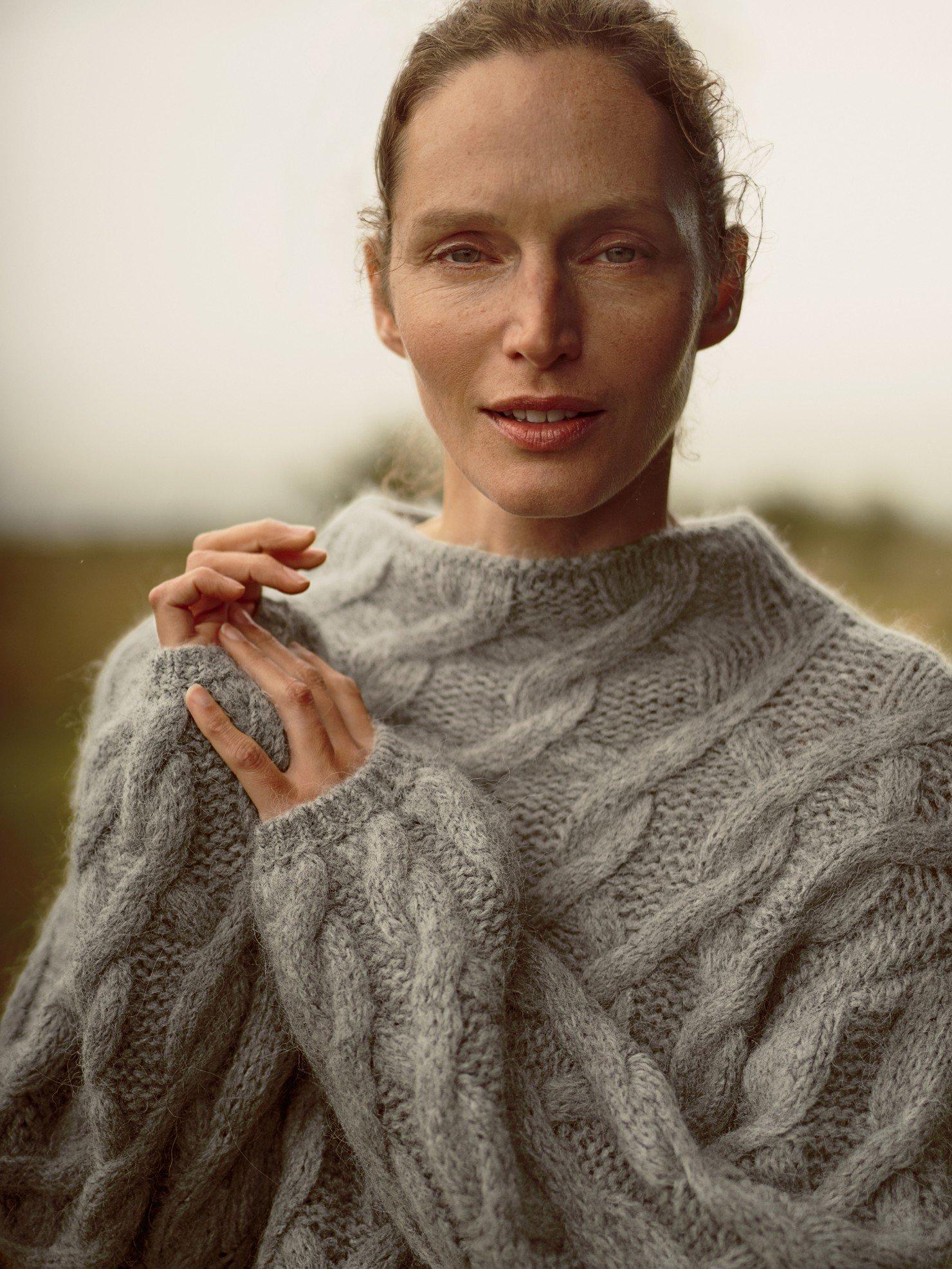 a woman with arms crossed standing next to a truck