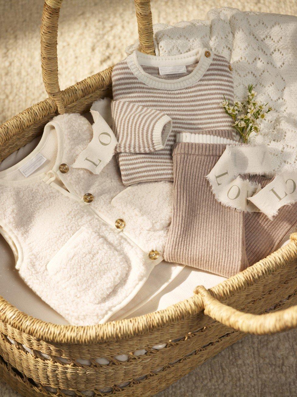 a basket with clothes and a card on the floor
