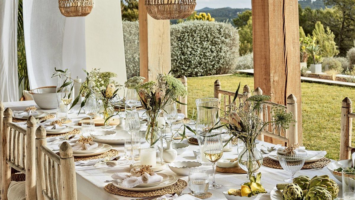 a table set for a dinner party outdoors on a patio
