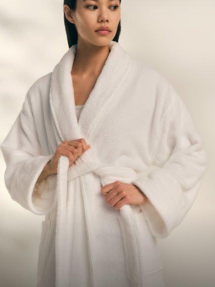 a woman in a white robe 