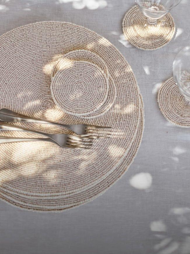 a table setting with a white cloth and silverware on it