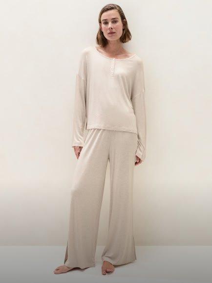 a woman in a white pajama top and pants
