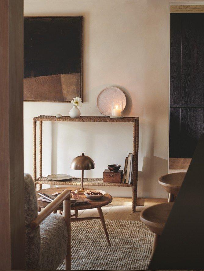 a living room with a chair and ottoman in a white room