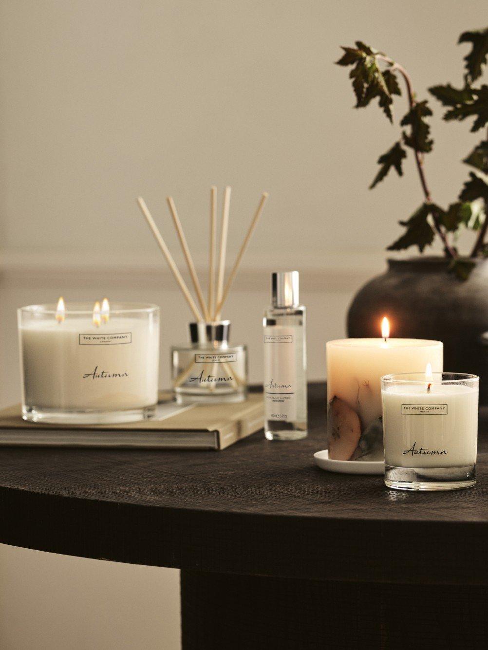 a table with candles and a vase of flowers on it