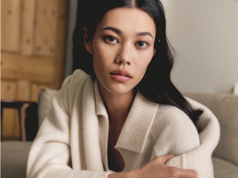 a woman sitting on a couch with her arms crossed