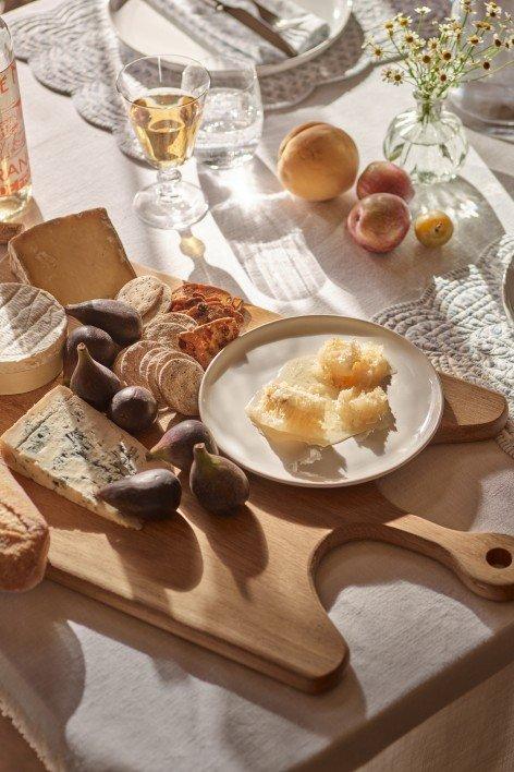 a table with a plate of food and a glass of wine