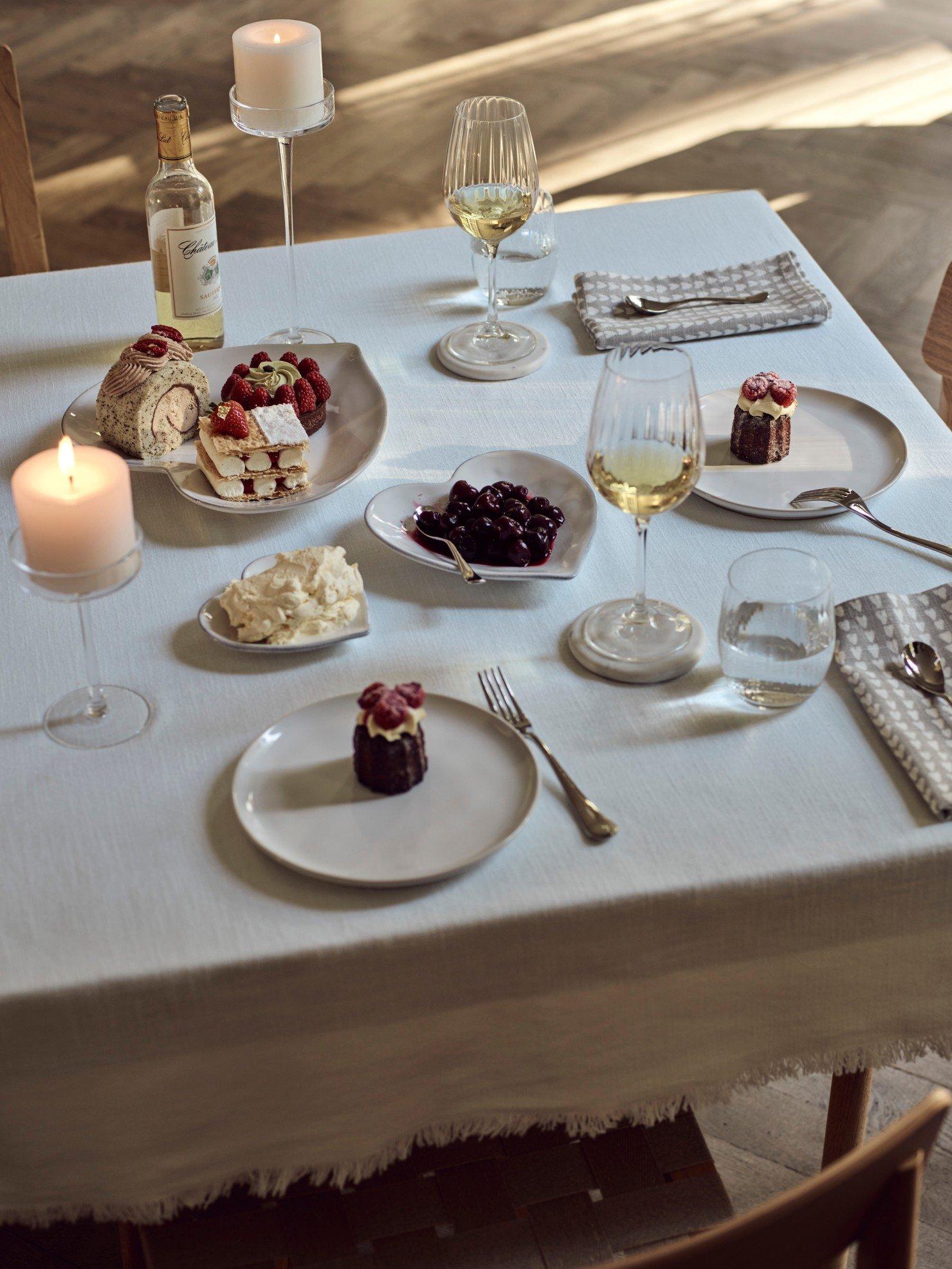 a table with a white table cloth and plates and glasses