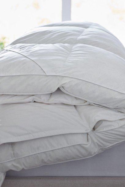 a close up of a white quilt and a white fur blanket